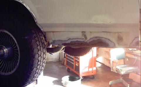 1985 Ford Crown Victoria LTD - The rocker panel of a 1985 Ford Crown Victoria LTD displays significant rust damage.