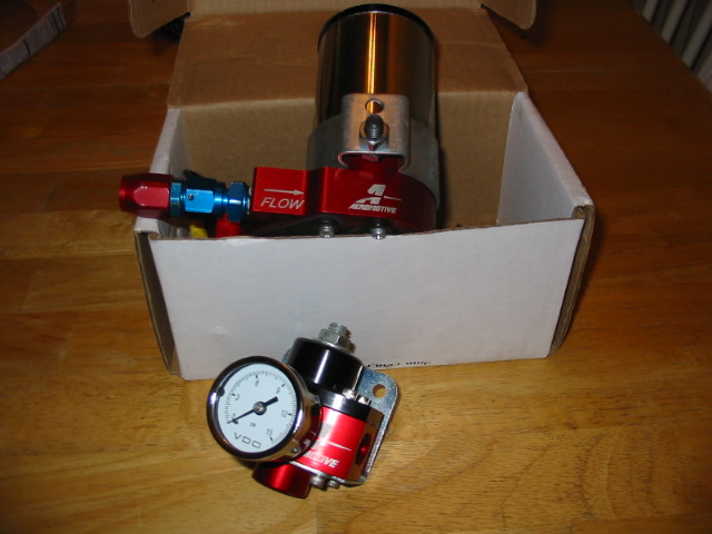 Red fuel pressure regulator with VDO gauge and 'FLOW' label