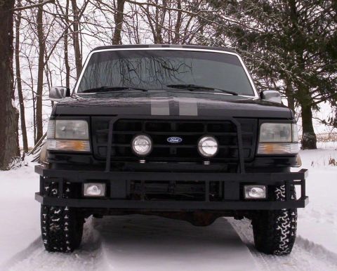 1993 Ford Bronco - Front view of a 1993 Ford Bronco in a snowy environment, equipped with a bull bar.