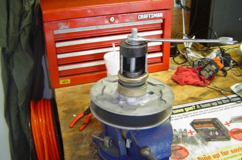1993 Ford Bronco - Clutch tool on pulley in vise with Craftsman toolbox and Supermotors ad visible.