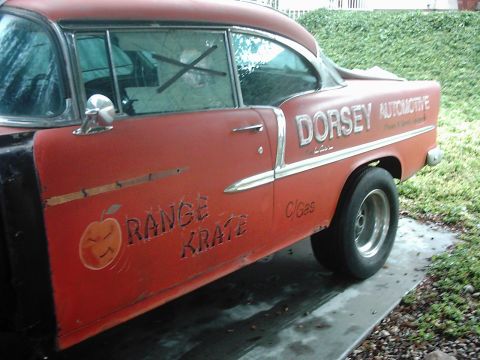 1978 Ford Bronco - Side view of an orange car with "Dorsey Automotive" and "Orange Krates" text, drag racing tires.
