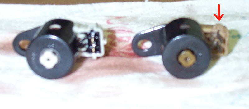 The arrow points to a "bump" on the side of the '93 solenoid. I found out, after installing it back in the transmission, that this won't let the CB plug in completely.