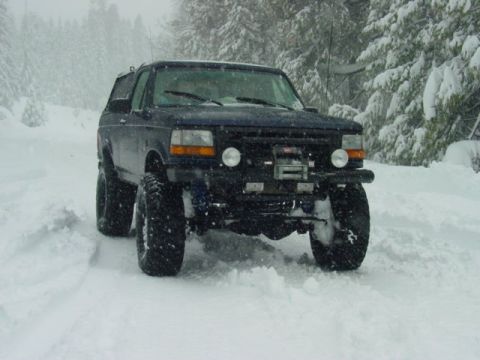1986 Ford Bronco - Ford Bronco navigates a snowy landscape, its off-road capabilities.
