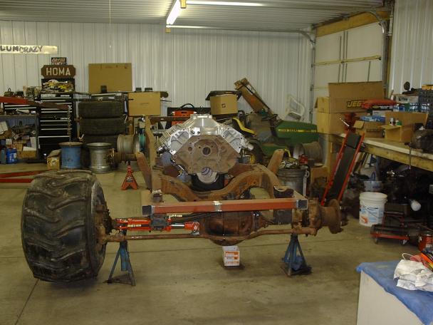 Truck chassis on stands with engine and large front tire