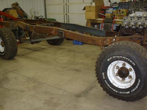 1978 Ford F-350 - A disassembled truck chassis sits in a garage, awaiting restoration or repair.