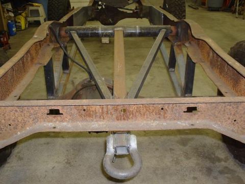 1978 Ford F-350 - The frame of a truck, showing the rear section with a tow hitch and significant rust.