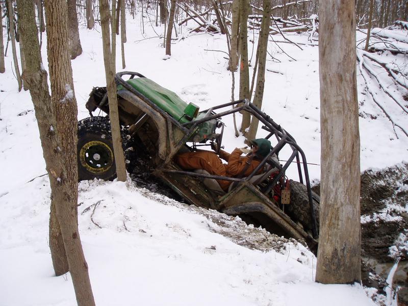 Off-road buggy tilted in snowy woods