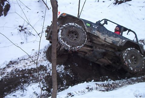 1992 Ford Bronco - Off-road vehicle navigates challenging terrain in snowy conditions.