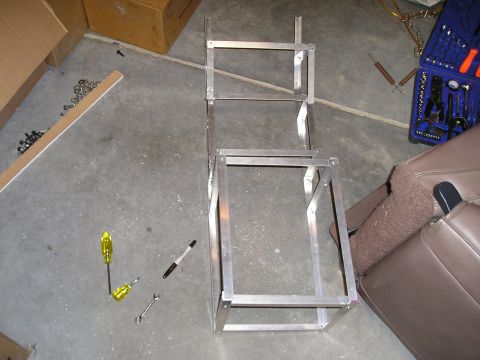 1996 Ford Bronco - An aluminum frame, likely for a custom center console, sits on a concrete floor next to tools and a car seat.