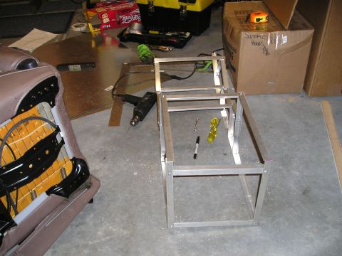 1996 Ford Bronco - A custom center console is being built with an aluminum frame, tools, and a car seat nearby.
