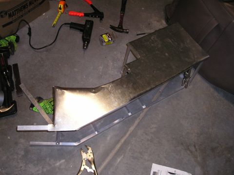 1996 Ford Bronco - A custom metal center console is being built on a workshop floor, surrounded by tools and materials.