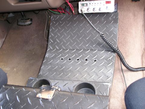 1996 Ford Bronco - Interior view of a custom diamond plate center console with a CB radio and microphone.
