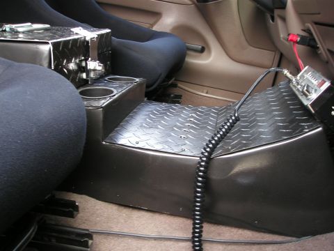 1996 Ford Bronco - Custom center console in a 1996 Ford Bronco features a CB radio and diamond plate accents.