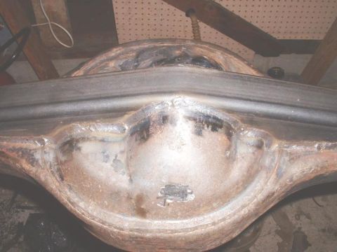 1995 Ford Bronco - Close-up view of a rusty rear axle housing, likely from an older vehicle.