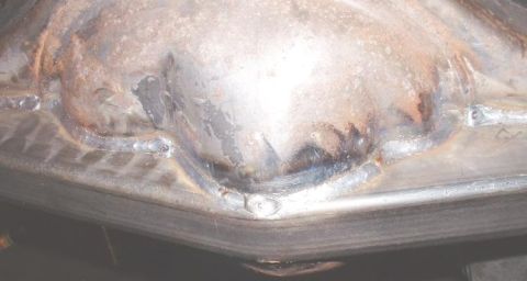 1995 Ford Bronco - This is a close-up view of a metal component showing signs of welding and surface rust.