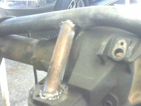 1995 Ford Bronco - Close-up of a rear axle housing custom tubing welded to the differential cover, suggesting aftermarket modifications.