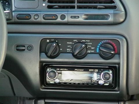 1995 Ford Contour - Interior view of a car's dashboard a Pioneer stereo system and climate controls, with a digital clock showing 11:12.