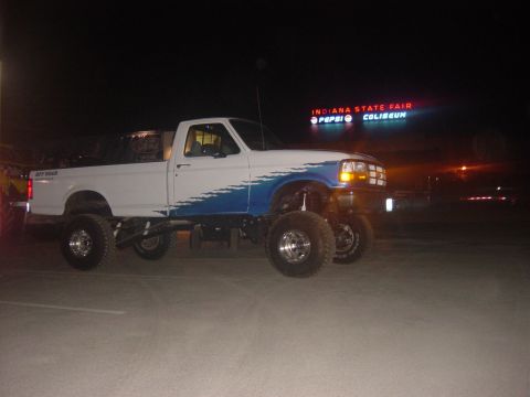 1983 Ford Bronco - A lifted pickup truck is parked at the Indiana State Fairgrounds at night, with the Coliseum sign illuminated.