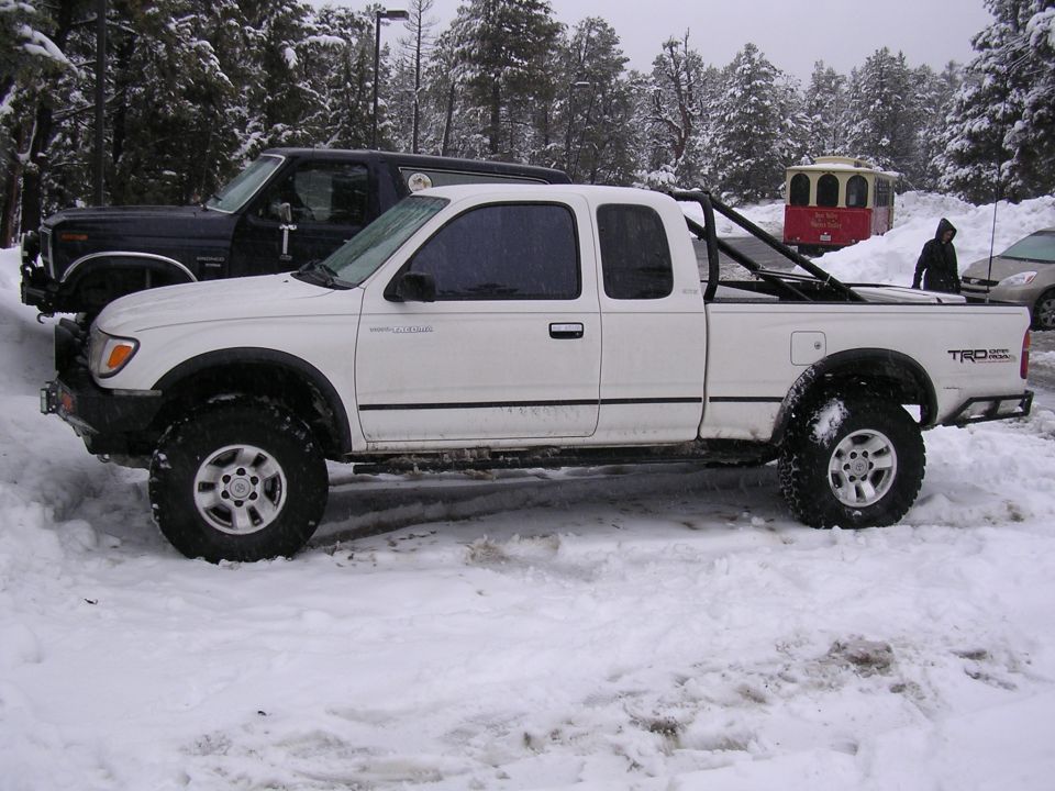 White 1999 Toyota Tacoma TRD off-road pickup truck in snow