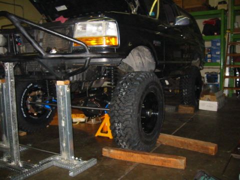 1992 Ford Bronco - This 1992 Ford Bronco is undergoing modifications with a custom suspension and off-road tires visible.