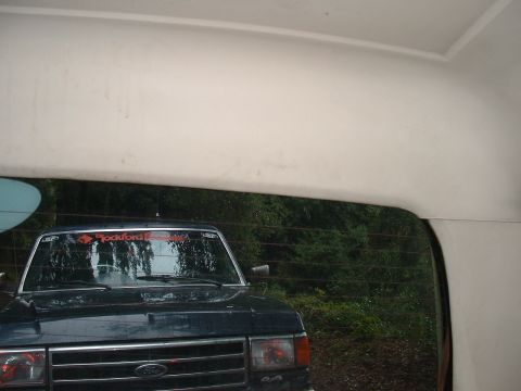 1991 Ford Bronco - A dark blue Ford Bronco is seen from the front, with a sticker on its windshield.