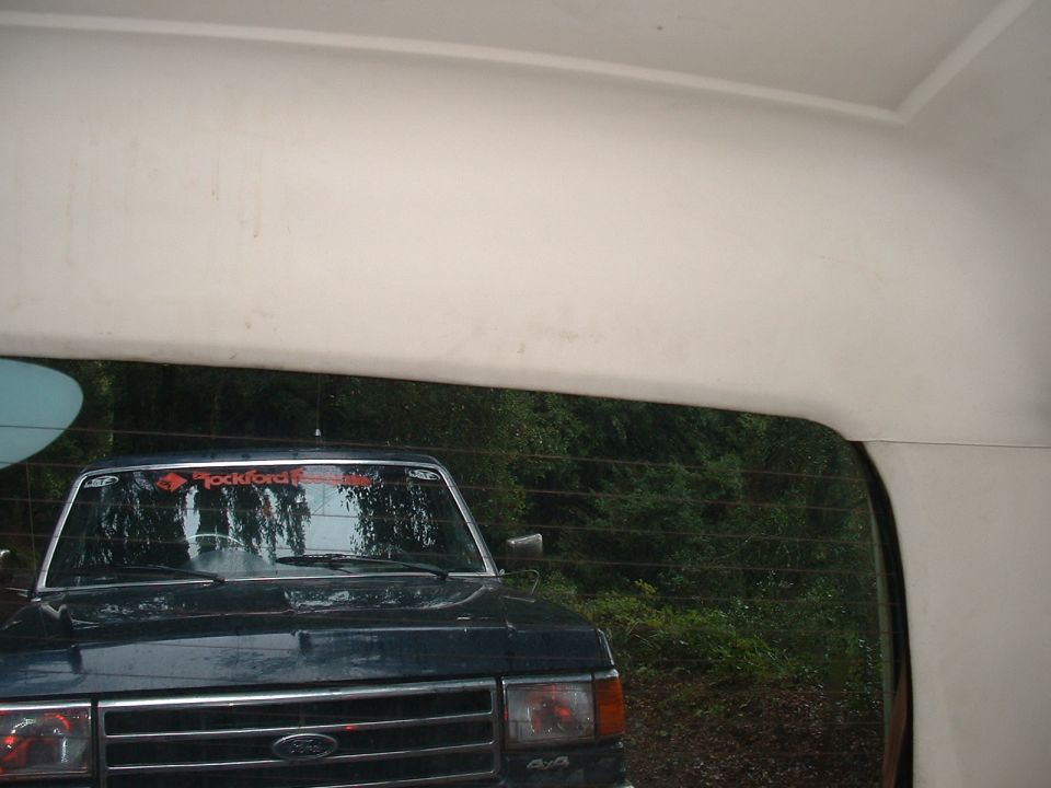 Dark blue Ford Bronco front view, with a Rockford Fosgate sticker on the windshield