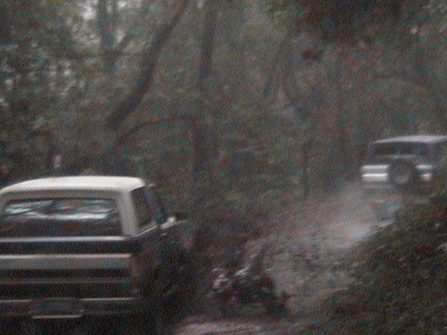 1991 Ford Bronco and another SUV on a dirt road