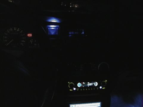 1995 Ford Contour - Interior view of a car at night with illuminated dashboard and stereo.