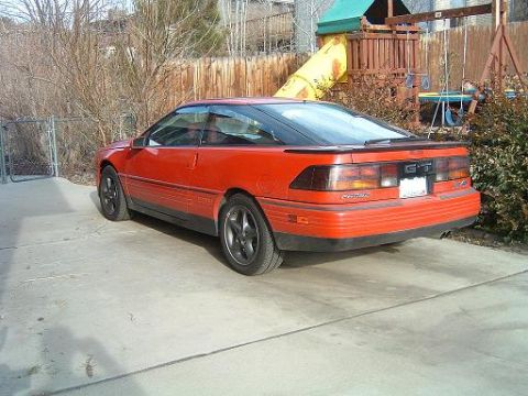 1989 Ford Probe - Rear view of a red 1989 Ford Probe GT with a spoiler and black trim.