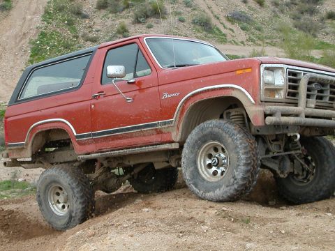 1993 Ford Bronco - This red Ford Bronco is equipped for off-road adventures on a dirt trail.