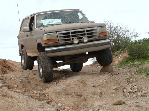 1993 Ford Bronco - This 1992 Ford Bronco navigates a rocky, off-road trail with its front passenger wheel elevated.