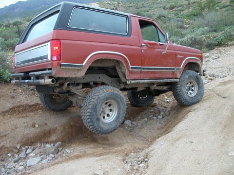 1993 Ford Bronco - This red Ford Bronco is equipped for off-road use, with a lifted suspension and large tires.
