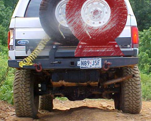 1988 Ford Bronco - Rear view of a 1988 Ford Bronco showing the spare tire and custom bumper.
