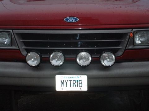 1994 Ford E350 - Front view of a red 1994 Ford E350 van, a grille with four fog lights and an Alaska license plate.