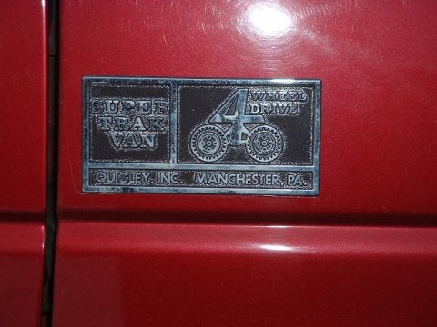1994 Ford E350 - This badge indicates a van modified for 4-wheel drive by Quigley, Inc.