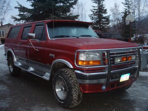 1996 Ford C-350 (Centurion Conversions) - Red 1996 Ford C-350 (Centurion Conversions) SUV parked outdoors with a brush guard and large tires.