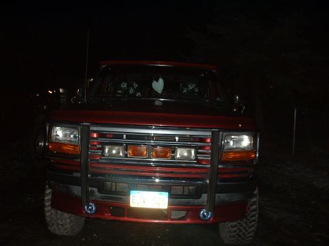 1996 Ford C-350 (Centurion Conversions) - Frontal view of a red Ford truck with a brush guard and visible license plate.