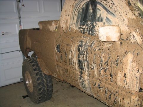 1986 Ford F-150 - Truck is heavily covered in mud, obscuring details like year and model.