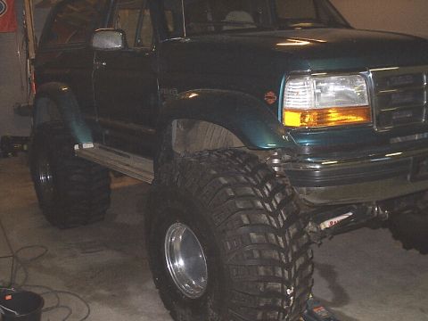 1996 Ford Bronco - This lifted Ford Bronco is equipped with massive off-road tires, suggesting it's ready for terrain.