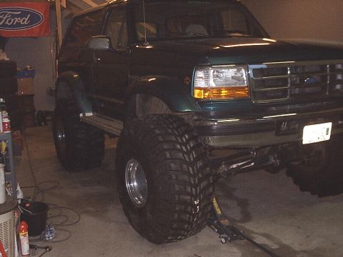 1996 Ford Bronco - This modified 1996 Ford Bronco features a significant lift and massive off-road tires, giving it an aggressive stance.