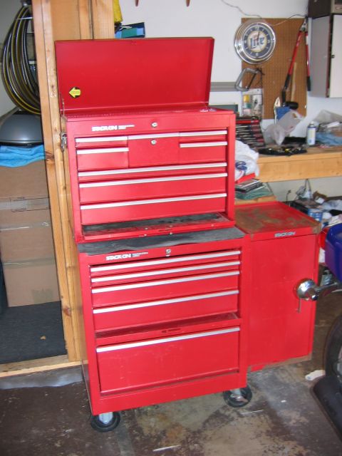 1985 Ford LTD Crown Victoria - A red metal toolbox with many drawers is shown in a garage setting.