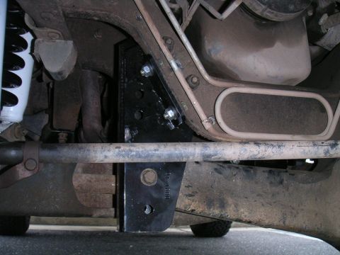 1994 Ford Bronco - Close-up of the vehicle's undercarriage, focusing on suspension and frame components.