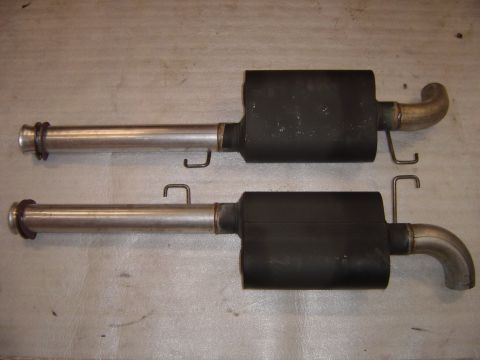 1978 Ford Bronco - Pair of exhaust mufflers with attached pipes and mounting hangers.