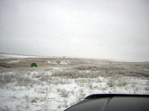 1995 Ford Bronco - Green SUV in a snowy landscape, seen from inside another vehicle.