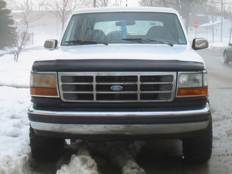 1992 Ford Bronco - Frontal view of a white 1992 Ford Bronco parked in a snowy environment.