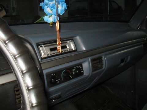 1992 Ford Bronco - Interior view of a 1992 Ford Bronco showing the dashboard, steering wheel, and an aftermarket stereo system.