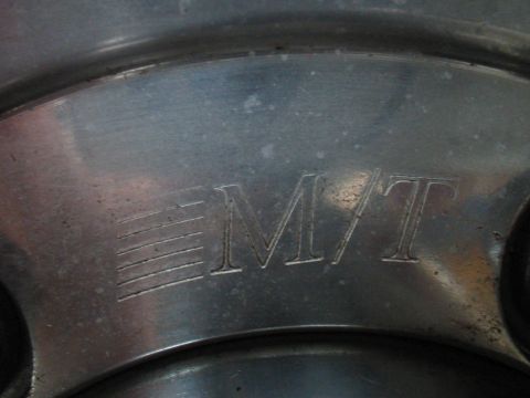 1992 Ford Bronco - A close-up view of a wheel shows the embossed "MT" logo and some horizontal line details.