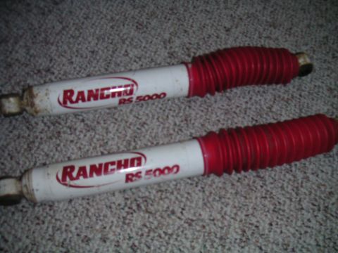 1994 Ford Bronco - Pair of Rancho RS 5000 shock absorbers with red dust boots.