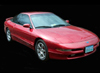 1996 Ford Probe - 1996 Ford Probe coupe, front 3/4 view. Black background.
