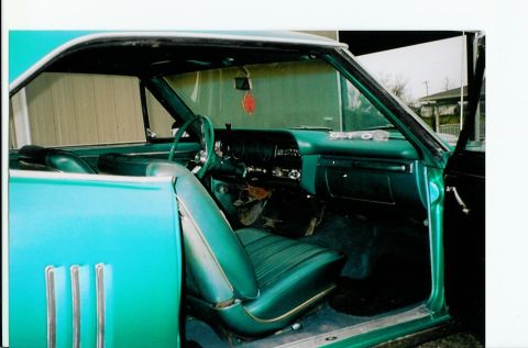 1967 Pontiac Lemans - The interior of a 1967 Pontiac LeMans convertible features green vinyl seats and a matching dashboard.